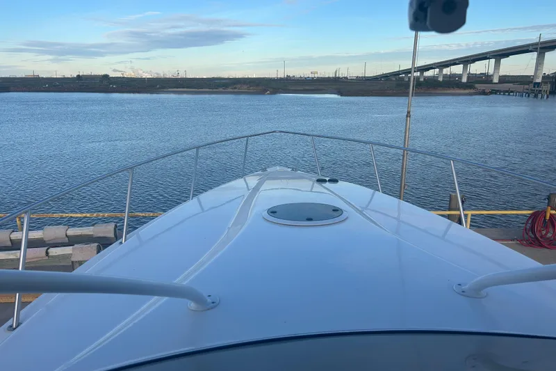  Yacht Photos Pics 2007 Fountain 38 Sportfish Cruiser OB docked by a calm waterfront.
