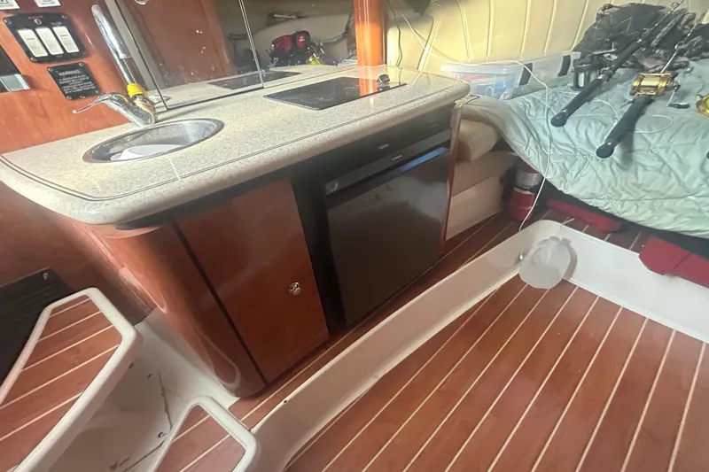  Yacht Photos Pics Interior of 2007 Fountain 38 Sportfish Cruiser OB with kitchenette and fishing gear.