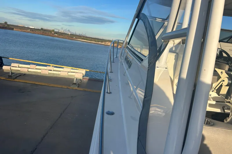  Yacht Photos Pics 2007 Fountain 38 Sportfish Cruiser OB docked by the water on a sunny day.