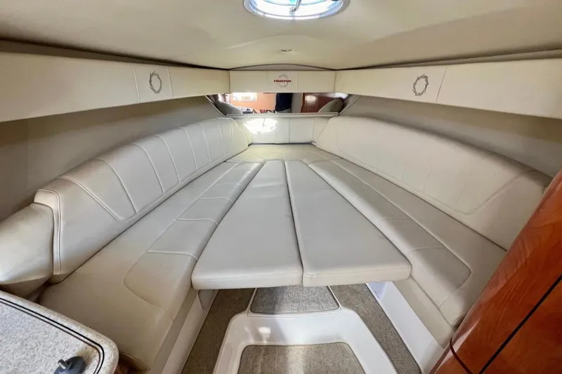  Yacht Photos Pics 2007 Fountain 38 Sportfish Cruiser OB cabin interior with beige seating and overhead hatch.