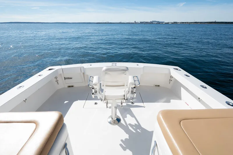 Salt Lick Yacht Photos Pics 2018 Albemarle 41 Express boat deck with fishing chair, overlooking calm ocean waters.
