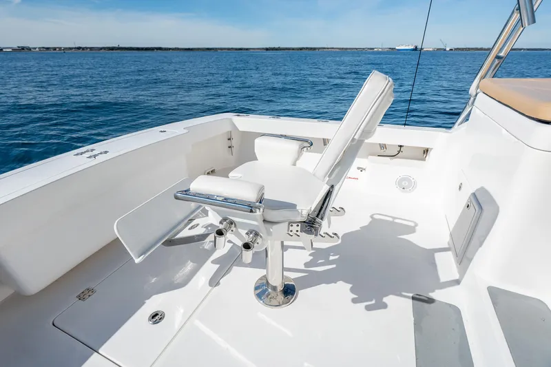 Salt Lick Yacht Photos Pics 2018 Albemarle 41 Express boat deck with fishing chair, overlooking calm blue waters.