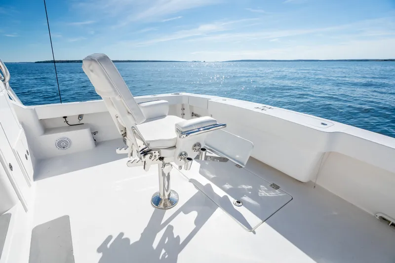 Salt Lick Yacht Photos Pics 2018 Albemarle 41 Express boat deck with fishing chair, overlooking calm ocean waters.