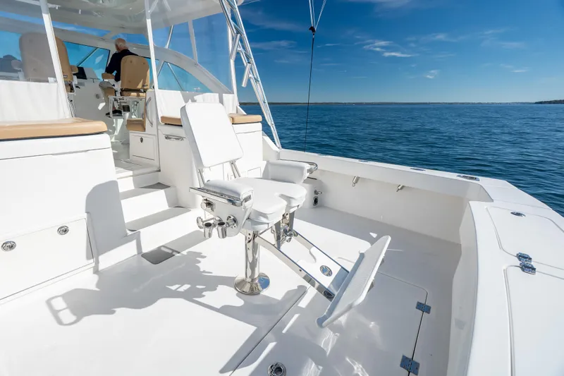 Salt Lick Yacht Photos Pics 2018 Albemarle 41 Express boat with fishing chair on open deck, ocean view.