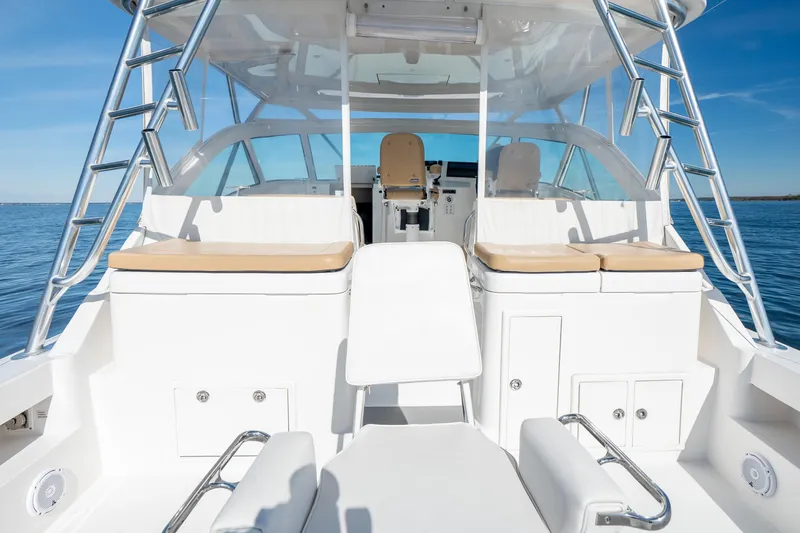 Salt Lick Yacht Photos Pics 2018 Albemarle 41 Express boat interior with seating and ladder, on calm water.