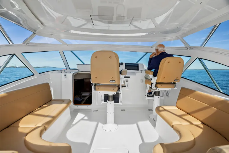 Salt Lick Yacht Photos Pics Interior of 2018 Albemarle 41 Express boat with seating and helm, overlooking the ocean.