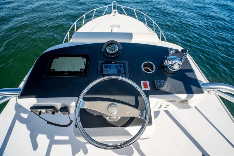 Salt Lick Yacht Photos Pics 2018 Albemarle 41 Express helm with navigation controls and steering wheel on open water.