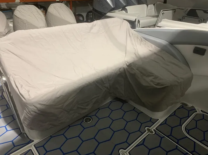  Yacht Photos Pics 2020 Mystic Powerboats M4200 interior with covered seating and hexagonal floor design.