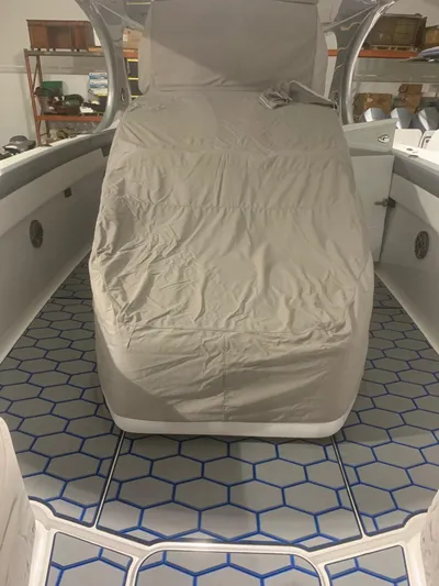  Yacht Photos Pics 2020 Mystic Powerboats M4200 interior with covered seating and hexagonal floor design.