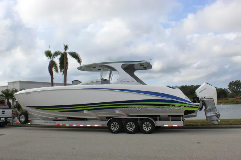  Yacht Photos Pics 2020 Mystic Powerboats M4200 on trailer, sleek design with vibrant blue and green accents.