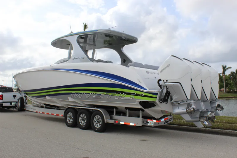  Yacht Photos Pics 2020 Mystic Powerboats M4200 on trailer with triple engines, parked by waterfront.