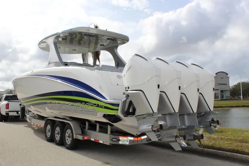  Yacht Photos Pics 2020 Mystic Powerboats M4200 with quad engines on a trailer by a lake.