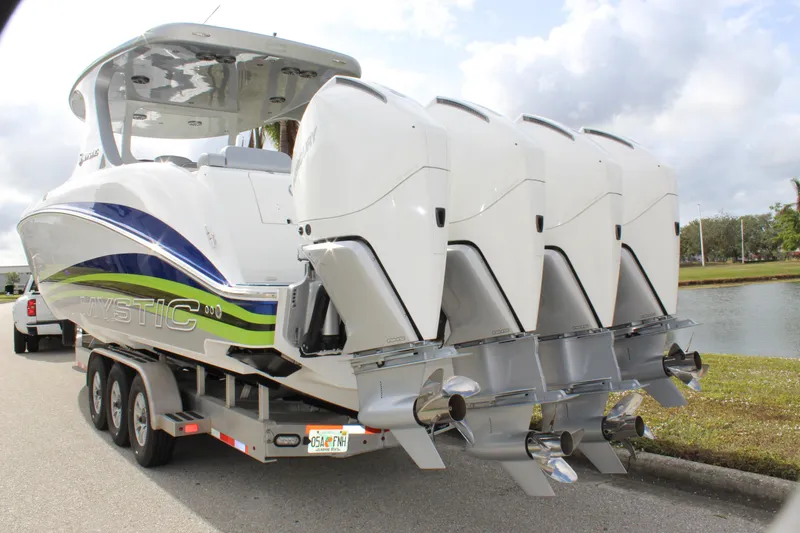  Yacht Photos Pics 2020 Mystic Powerboats M4200 with quad engines on a trailer by a lake.