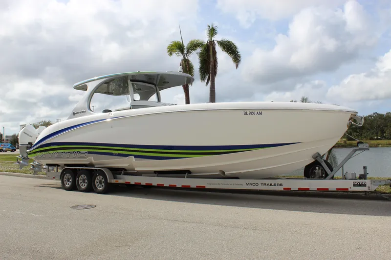  Yacht Photos Pics 2020 Mystic Powerboats M4200 on trailer, sleek design with blue and green accents.