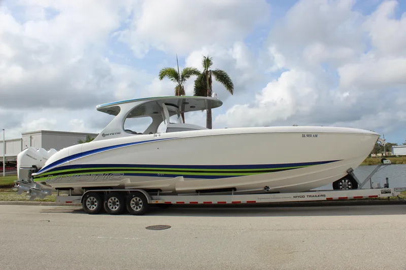  Yacht Photos Pics 2020 Mystic Powerboats M4200 on trailer, sleek design with blue and green accents.