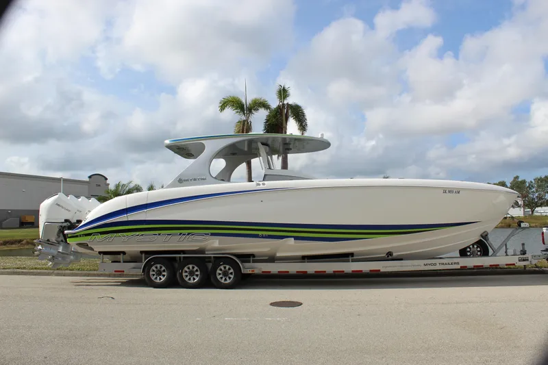  Yacht Photos Pics 2020 Mystic Powerboats M4200 on trailer, sleek design with blue and green accents.