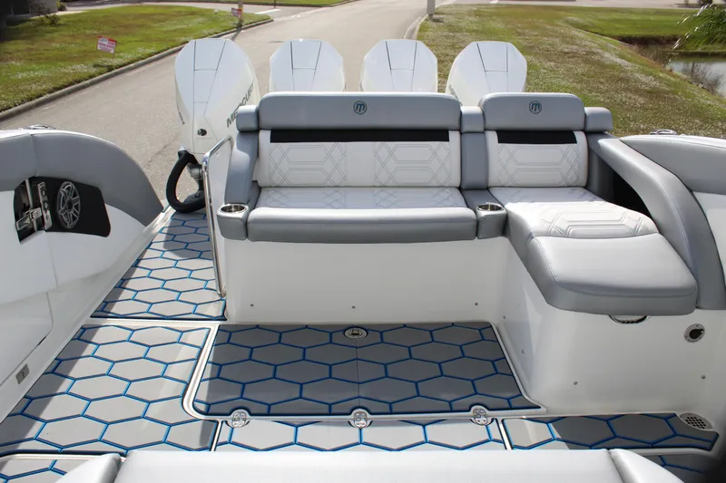  Yacht Photos Pics 2020 Mystic Powerboats M4200 interior with stylish seating and hexagonal floor design.