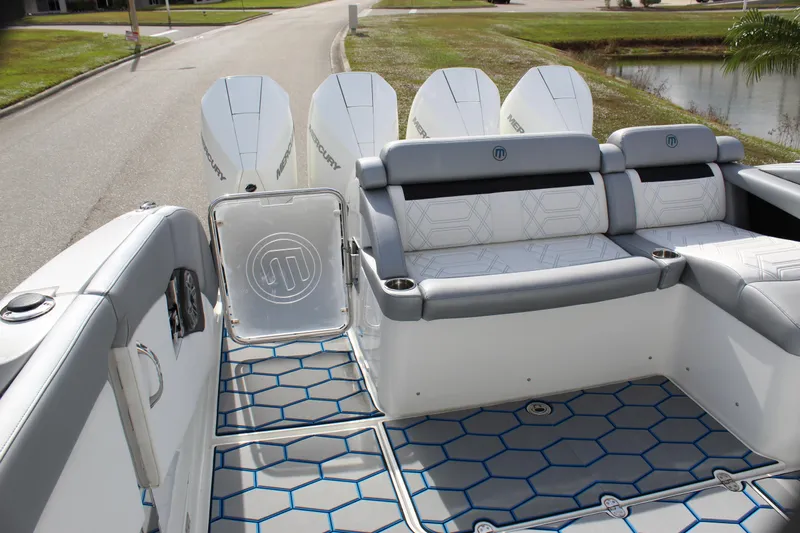  Yacht Photos Pics 2020 Mystic Powerboats M4200 interior with stylish seating and powerful outboard engines.