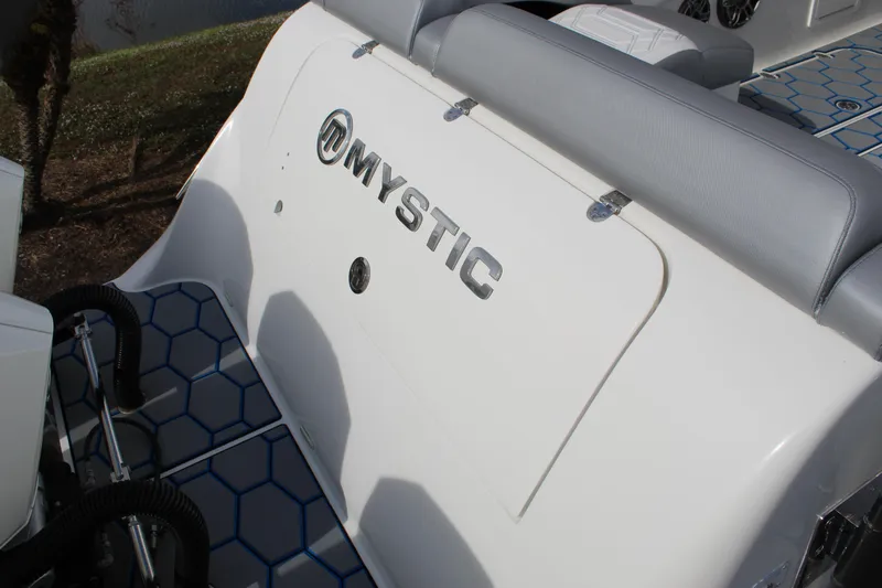  Yacht Photos Pics 2020 Mystic Powerboats M4200, white seating area with logo, blue hexagonal flooring.