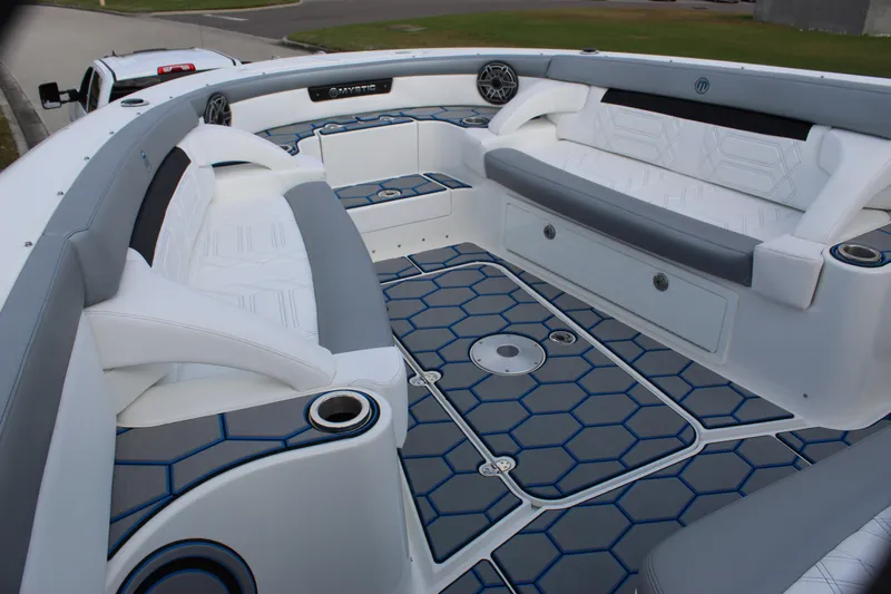  Yacht Photos Pics 2020 Mystic Powerboats M4200 interior with hexagonal flooring and cushioned seating.