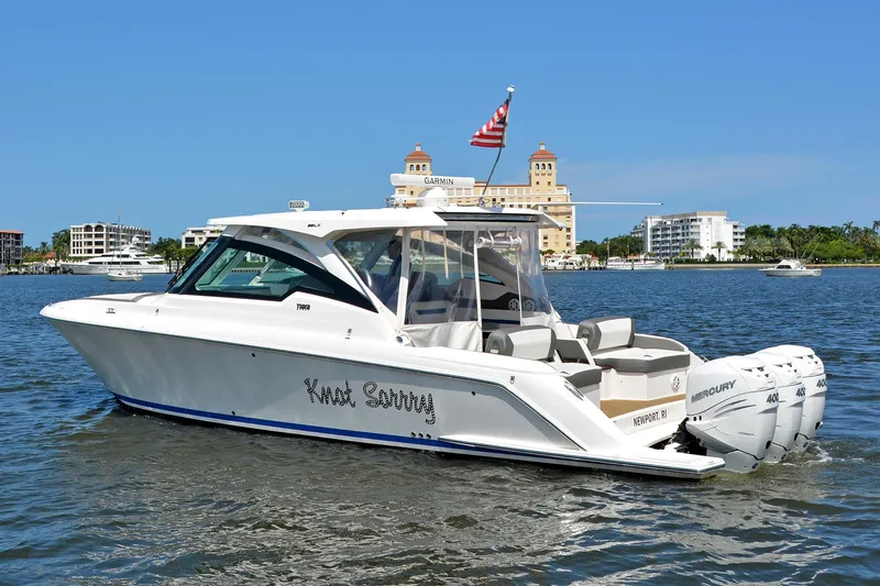 Knot Sorry Yacht Photos Pics 2021 Tiara Yachts 38LX boat on water with cityscape background.