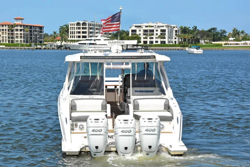 Knot Sorry Yacht Photos Pics 2021 Tiara Yachts 38LX with triple 400 engines on a sunny waterfront.