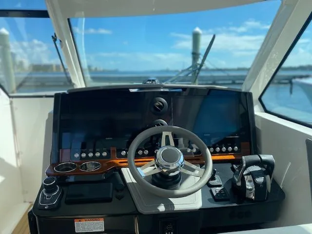 Knot Sorry Yacht Photos Pics Helm of 2021 Tiara Yachts 38LX with modern controls and ocean view.