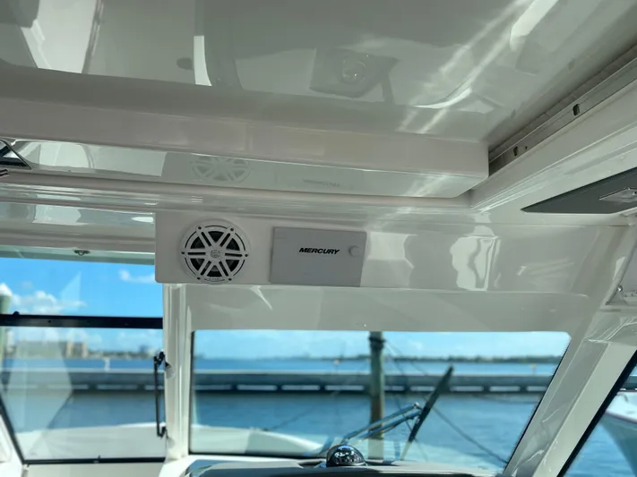 Knot Sorry Yacht Photos Pics 2021 Tiara Yachts 38LX interior with Mercury speaker, ocean view in background.