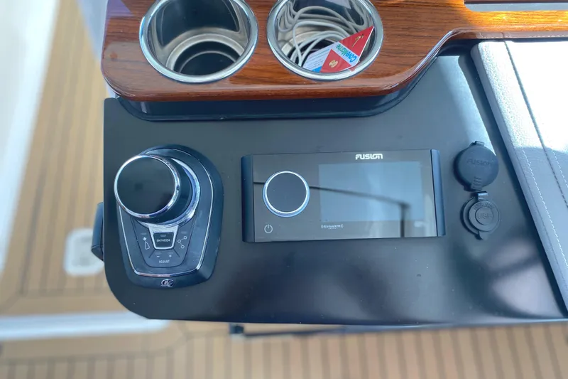 Knot Sorry Yacht Photos Pics Control panel of 2021 Tiara Yachts 38LX with Fusion audio system and cup holders.