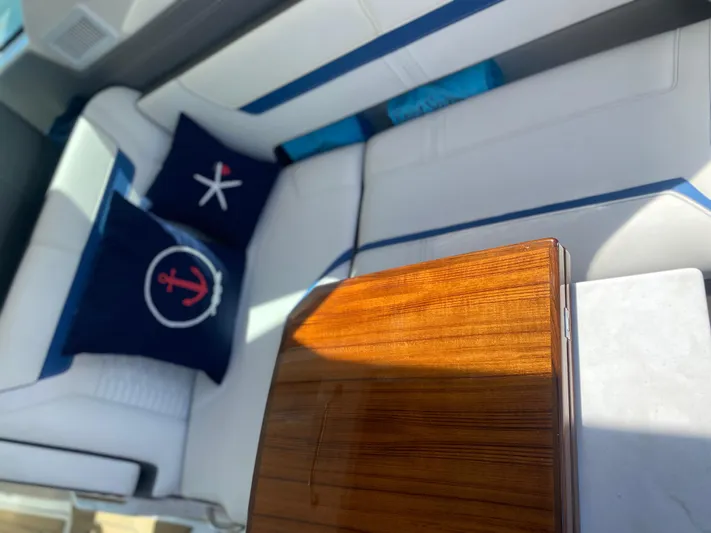 Knot Sorry Yacht Photos Pics Luxurious interior of 2021 Tiara Yachts 38LX with nautical-themed cushions.