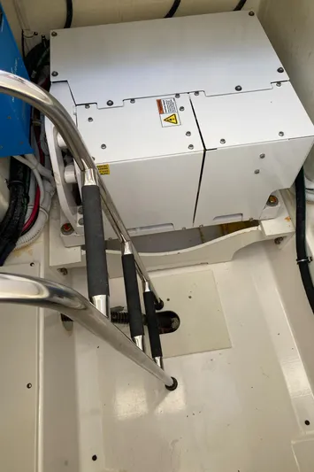 Knot Sorry Yacht Photos Pics Engine compartment of 2021 Tiara Yachts 38LX with visible equipment and ladder.