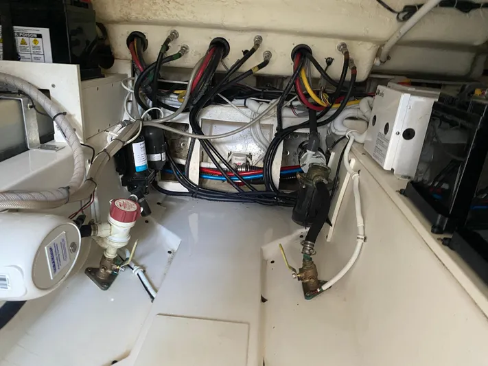 Knot Sorry Yacht Photos Pics Engine compartment of a 2021 Tiara Yachts 38LX, showcasing wiring and mechanical components.