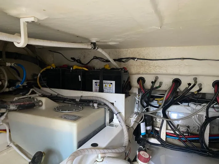 Knot Sorry Yacht Photos Pics Engine compartment of 2021 Tiara Yachts 38LX, showing batteries and wiring.