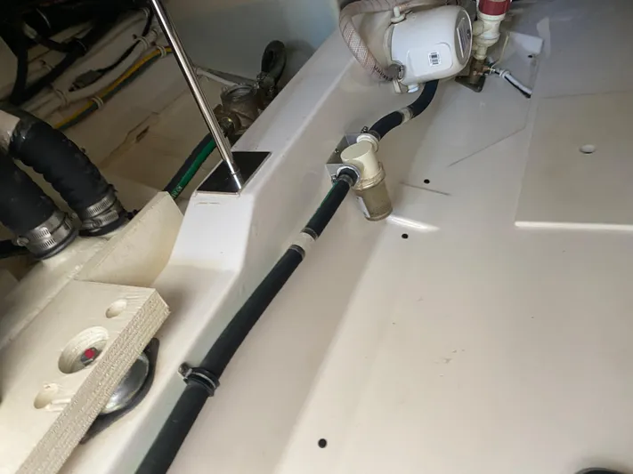 Knot Sorry Yacht Photos Pics Engine compartment of a 2021 Tiara Yachts 38LX, showcasing hoses and fittings.