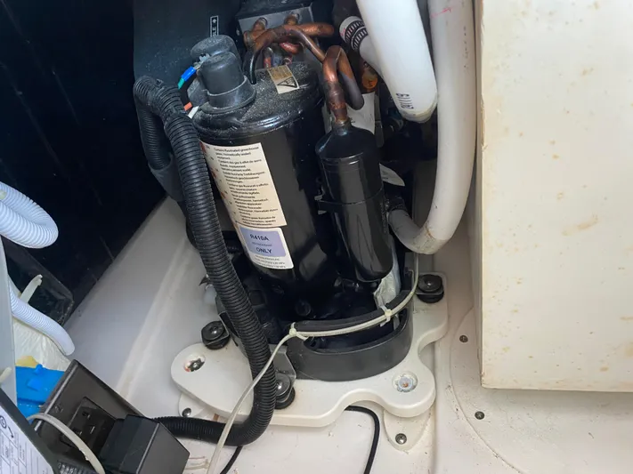 Knot Sorry Yacht Photos Pics Engine compartment of a 2021 Tiara Yachts 38LX, featuring mechanical components and wiring.