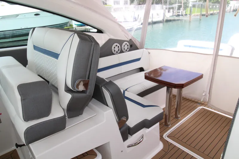 Knot Sorry Yacht Photos Pics Luxurious interior of 2021 Tiara Yachts 38LX with elegant seating and wooden table.