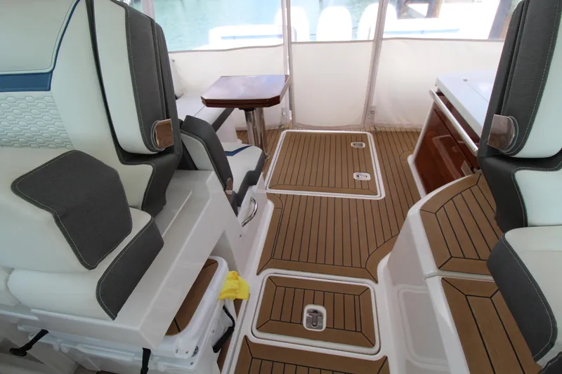Knot Sorry Yacht Photos Pics Interior of 2021 Tiara Yachts 38LX, featuring luxurious seating and teak flooring.