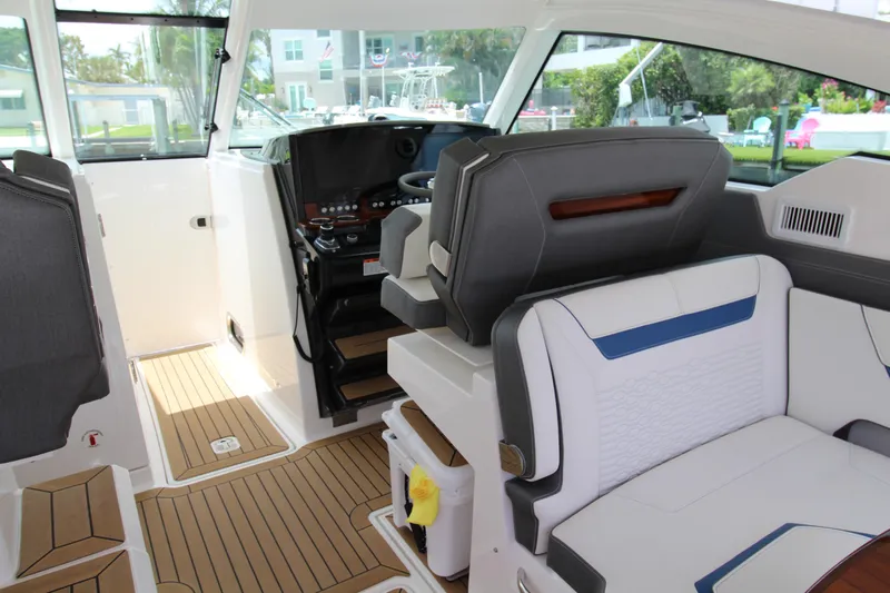 Knot Sorry Yacht Photos Pics 2021 Tiara Yachts 38LX interior with modern seating and sleek dashboard design.