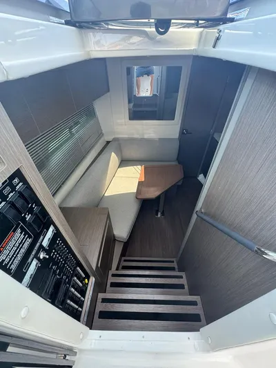  Yacht Photos Pics 2024 Beneteau Gran Turismo 36 interior cabin with seating and control panel.