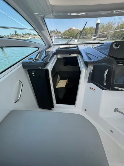  Yacht Photos Pics 2024 Beneteau Gran Turismo 36 cockpit with open storage compartment and sleek design.