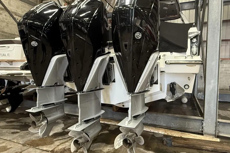  Yacht Photos Pics 2023 Monterey 385 Super Sport with triple outboard engines in a storage facility.