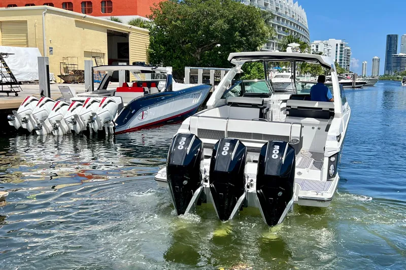  Yacht Photos Pics 2023 Monterey 385 Super Sport boat with triple outboard engines docked in a marina.
