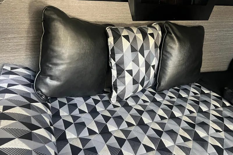  Yacht Photos Pics Luxurious interior of 2023 Monterey 385 Super Sport with geometric-patterned cushions.