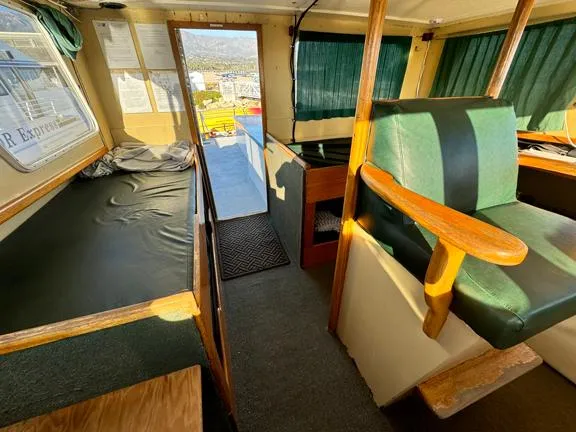 Truth Yacht Photos Pics Interior of a 1974 Custom Expedition Liveaboard boat with seating and sleeping area.
