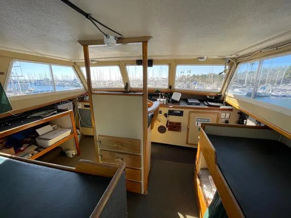 Truth Yacht Photos Pics Interior of 1974 Custom Expedition Liveaboard boat with navigation area and seating.