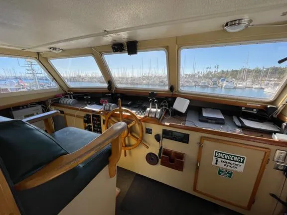 Truth Yacht Photos Pics Interior of 1974 Custom Expedition Liveaboard boat with steering wheel and control panel.
