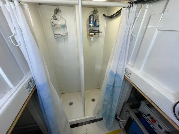 Truth Yacht Photos Pics Two shower stalls with curtains on a 1974 Custom Expedition Liveaboard boat.