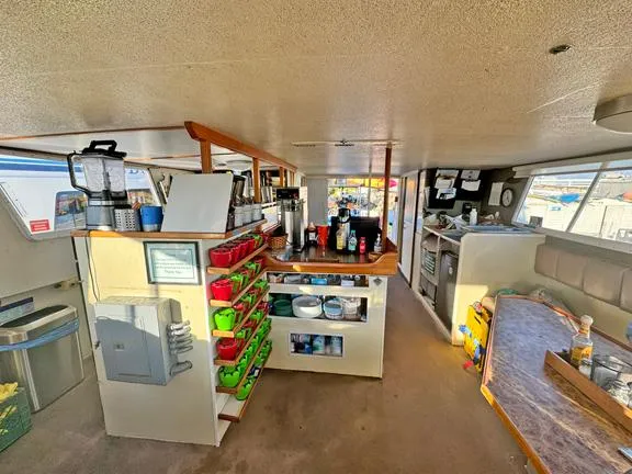 Truth Yacht Photos Pics Interior of a 1974 Custom Expedition Liveaboard with organized kitchen and seating area.