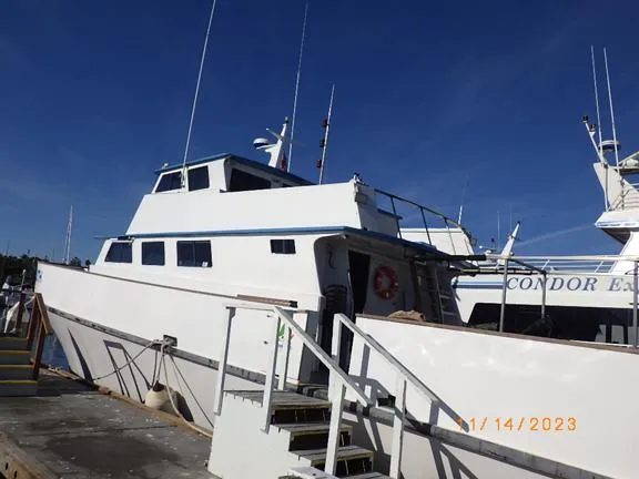 Truth Yacht Photos Pics 1974 Custom Expedition Liveaboard boat docked under clear blue sky.