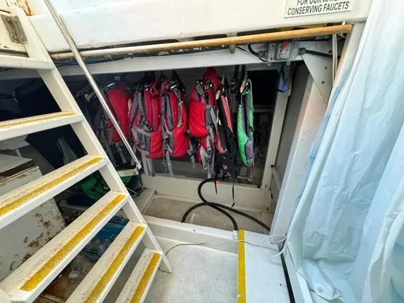 Truth Yacht Photos Pics Staircase on 1974 Custom Expedition Liveaboard with hanging red life jackets.